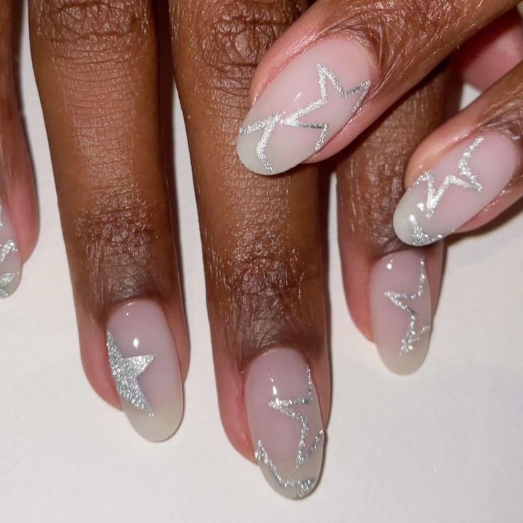 Whimsical Chic: Soft Nude Nails with Delicate Silver Star Accents.