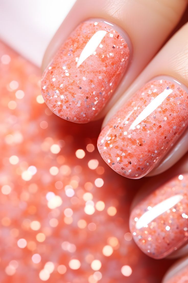 Radiant Sparkling Peach Nail Design: A Glamorous Blend of Coral and Glitter for Every Occasion.