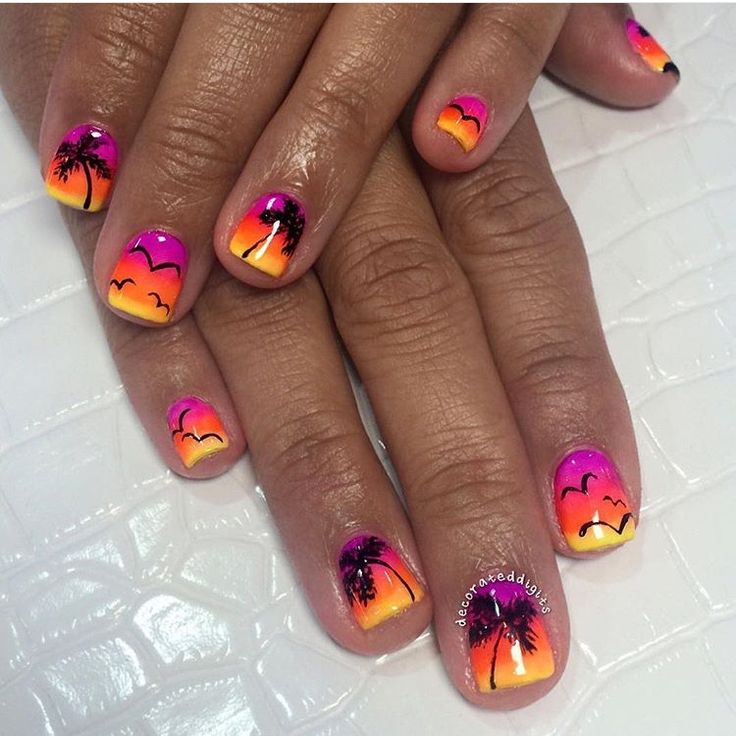 Tropical Sunset-Inspired Nail Art with Gradient Hues and Playful Designs.