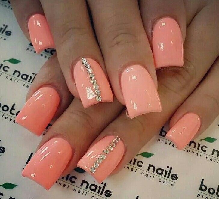 Elegant Soft Peach Nail Design with Glossy Finish and Rhinestone Accent.