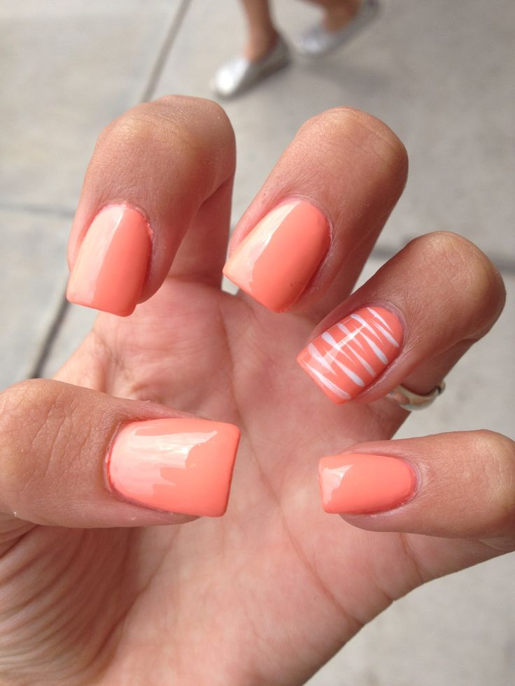 Vibrant Coral Nail Design: A Perfect Mix of Glossy Simplicity and Playful Stripes for Summer.