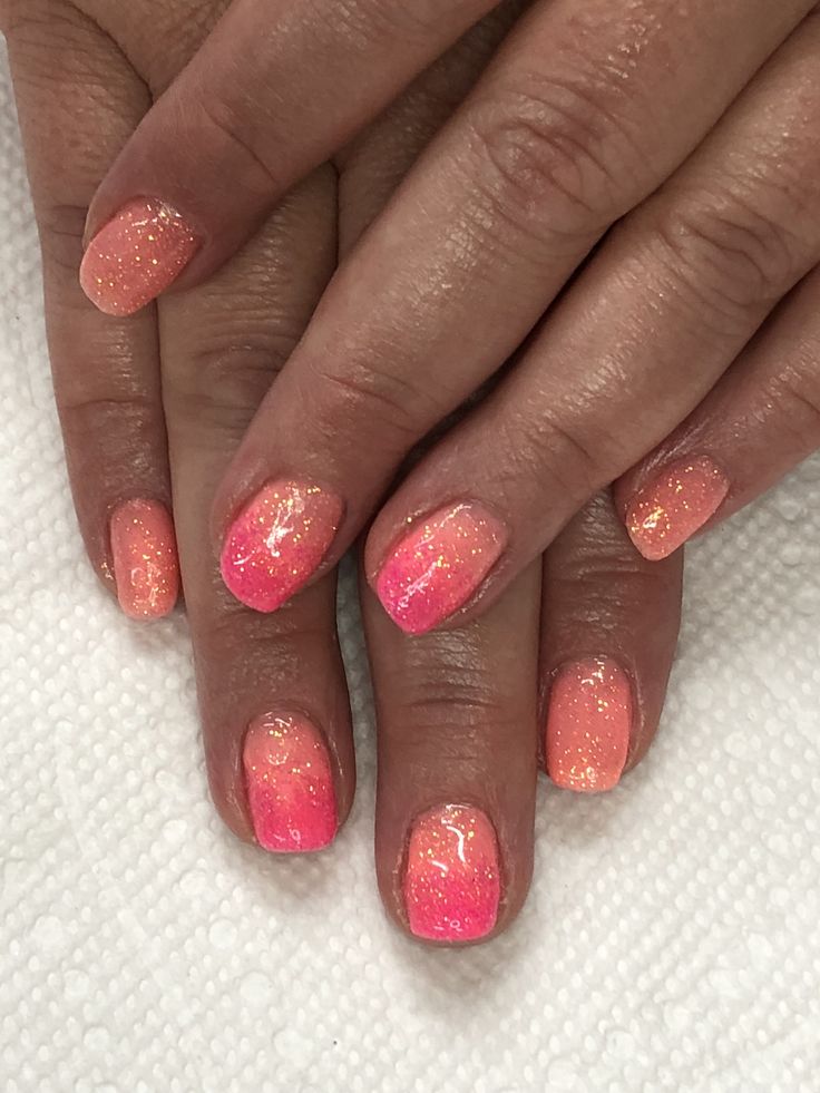 Playful Ombre Nail Design: Gradient Peach to Vibrant Pink with Glamorous Shimmer for Summer.