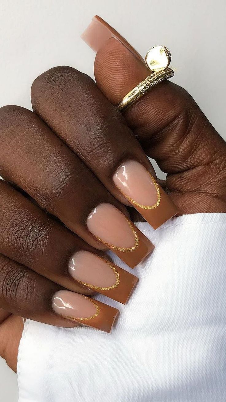 Sophisticated Nude Nail Design with Glossy Finish and Elegant Gold Accents.