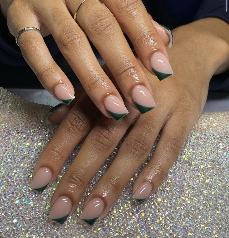 Sophisticated Nail Design: Soft Nude Base with Striking Dark Green Tips