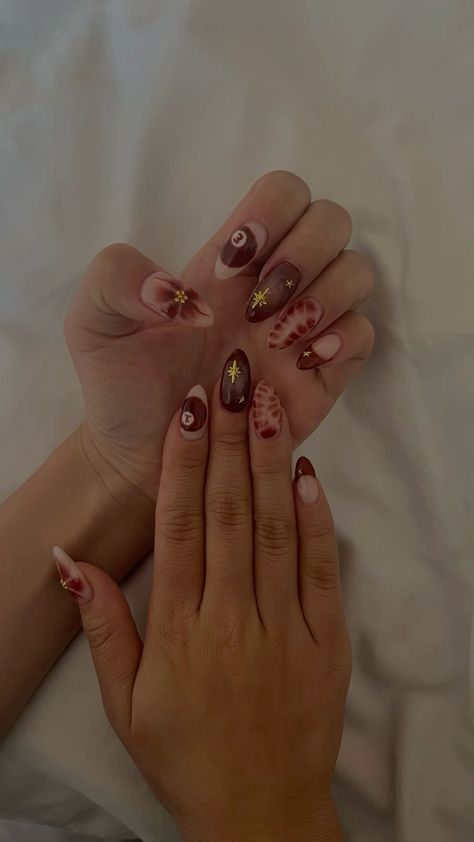 Chic Brown and Beige Nail Design with Golden Accents and Unique Patterns.