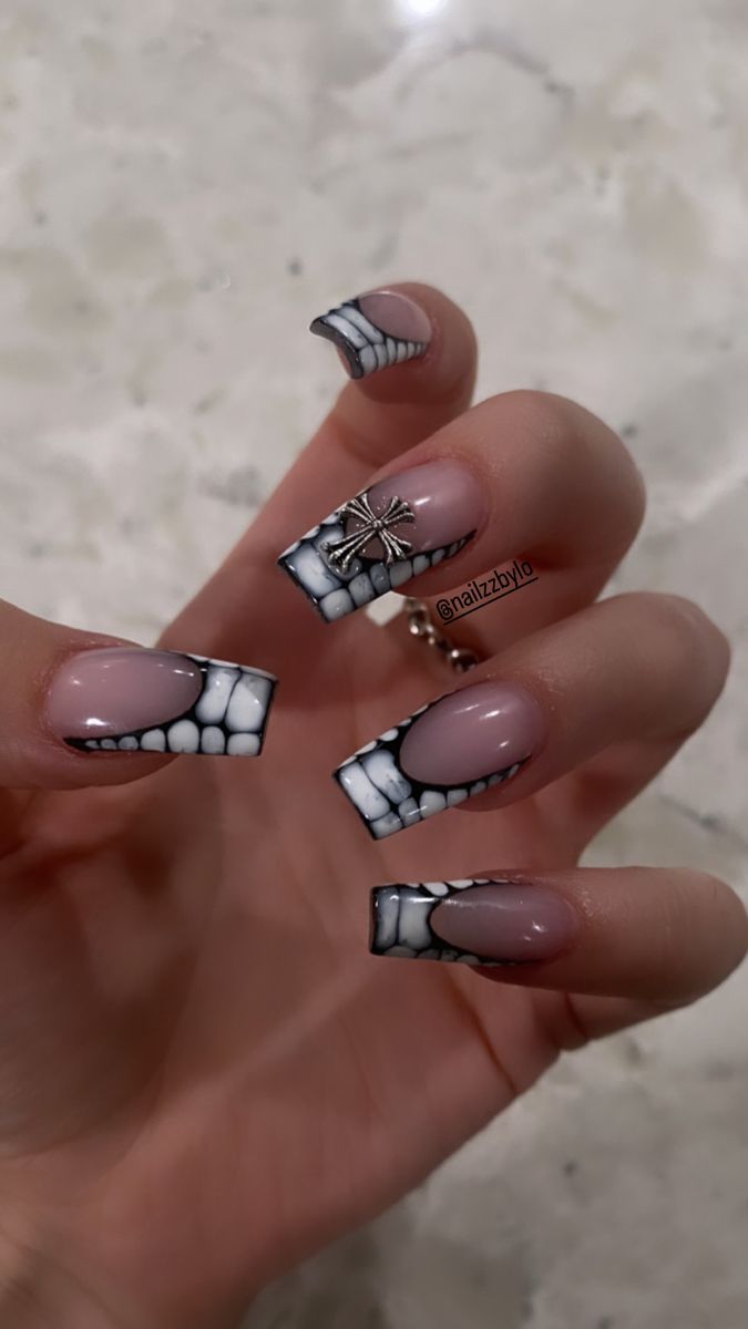 Edgy Skeletal Nail Art: Striking Teeth Design with Metallic Charm