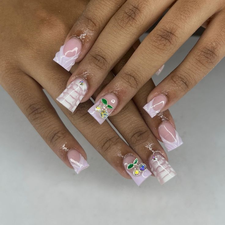 Chic Soft Pink and Lavender Nail Design with Elegant White Tips and Gemstone Accents.