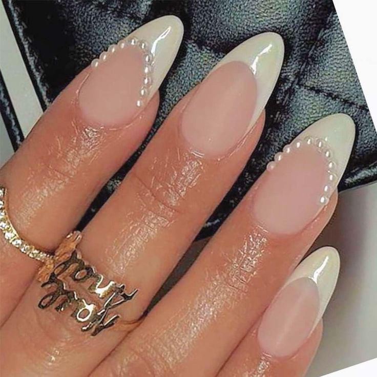 Chic French Manicure: Elegant Almond-Shaped Nails with Glossy Tips and Pearl Accents.