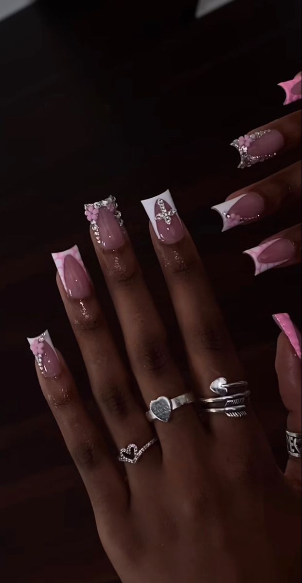 Chic Soft Pink and White Nail Design with Sparkle Accents and Floral Embellishments