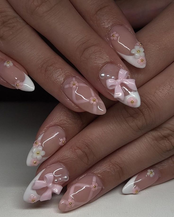 Chic and Playful Nude and White Nail Design with Pink Bows and Floral Accents.