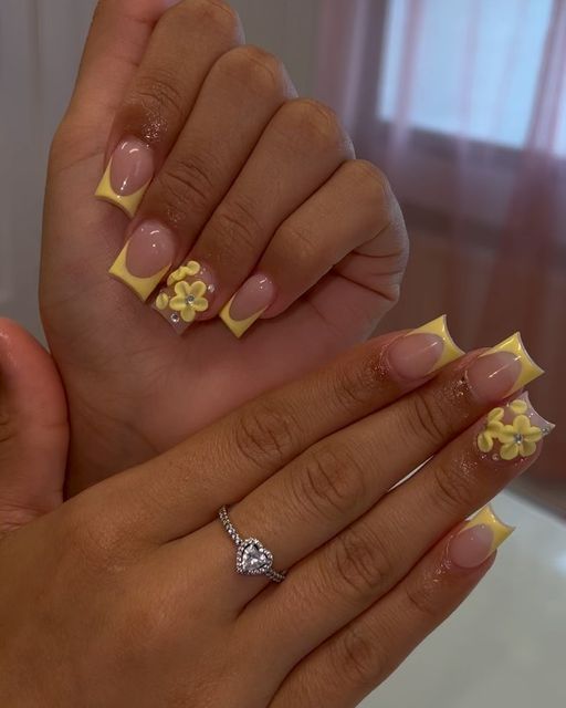 Elegant Floral Nail Design with Soft Yellow Tips and Clear Base.