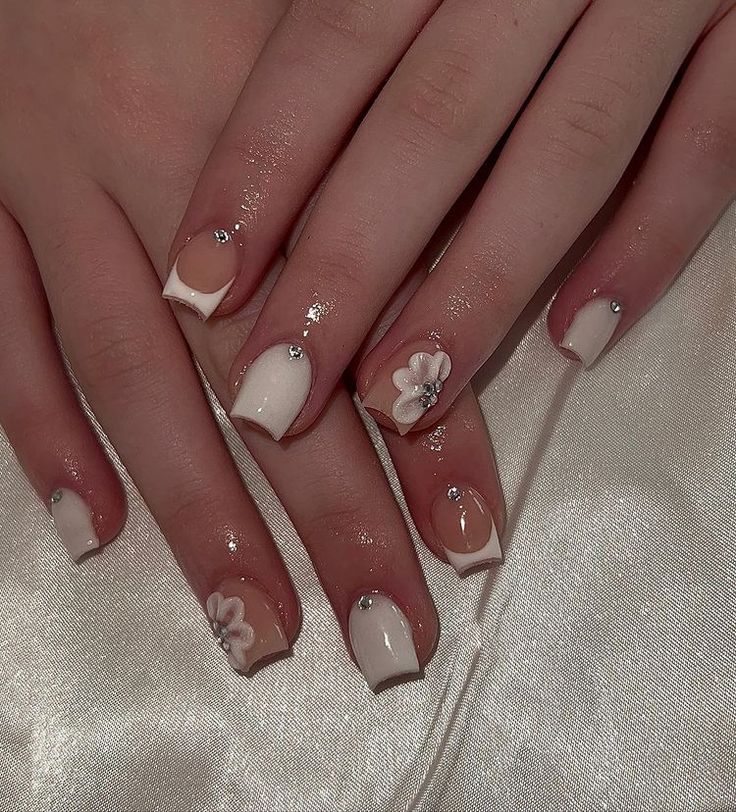 Chic Soft Nude Nail Design with French Tips and Floral Accents