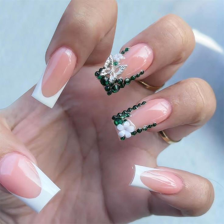 Sophisticated Nail Design: Soft Pink and French Tips with Floral Accents.