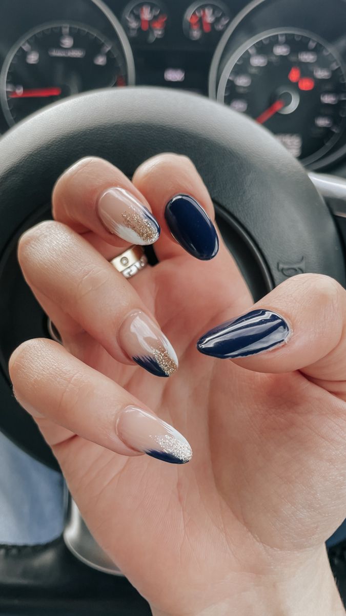 Chic Almond-Shaped Nail Design with Striking Navy, Nude, and Gold Textures.