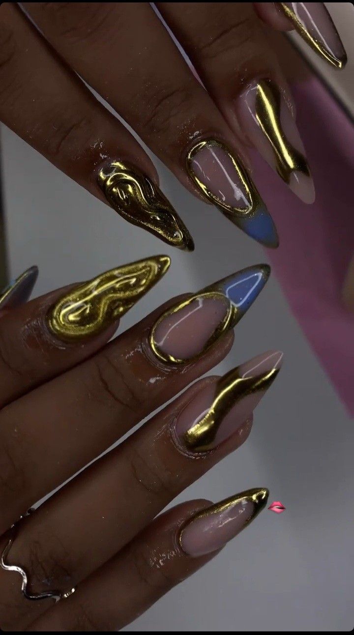 Elegant Gold and Pastel Nail Design with Wave Patterns.