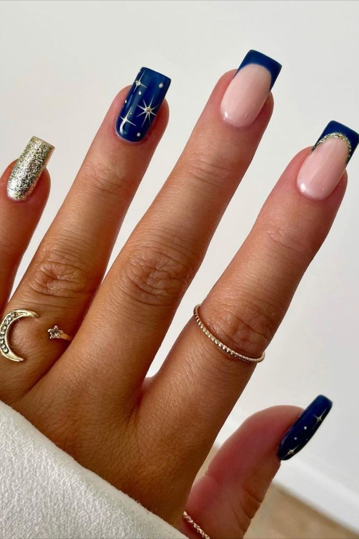 Chic Navy Blue and Soft Pink Nail Design with Glittering Gold Accents and Whimsical Star Patterns.