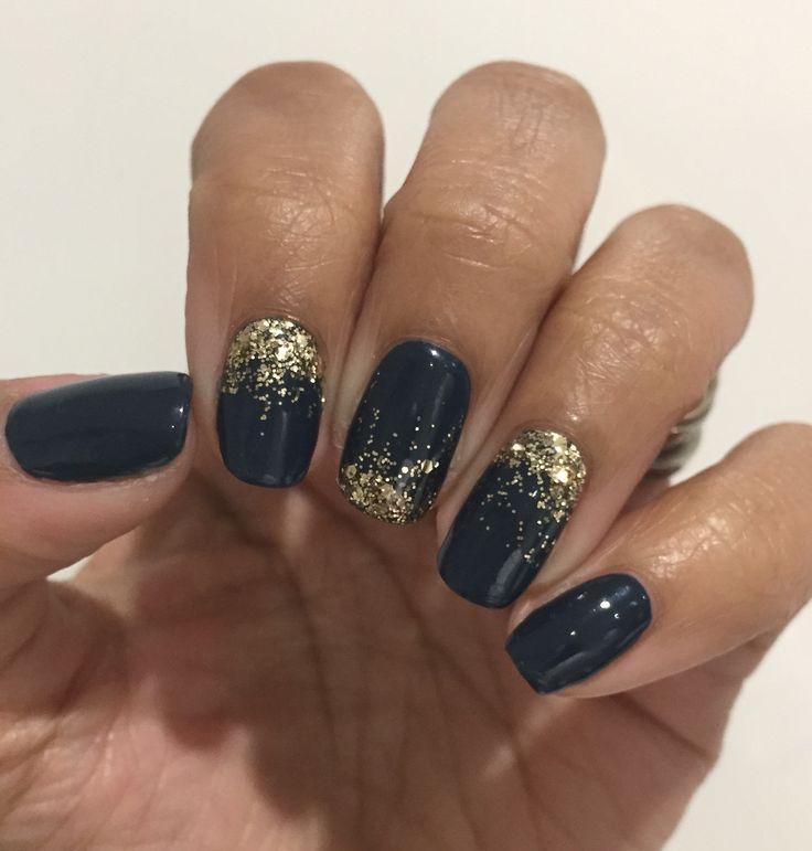 Chic Deep Navy Nail Design with Glittering Gold Accents for Glamorous Occasions.