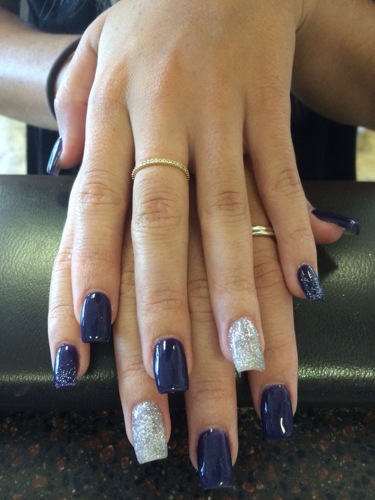 Sophisticated Navy Blue and Sparkling Silver Nail Design with Intricate Glitter Accents.