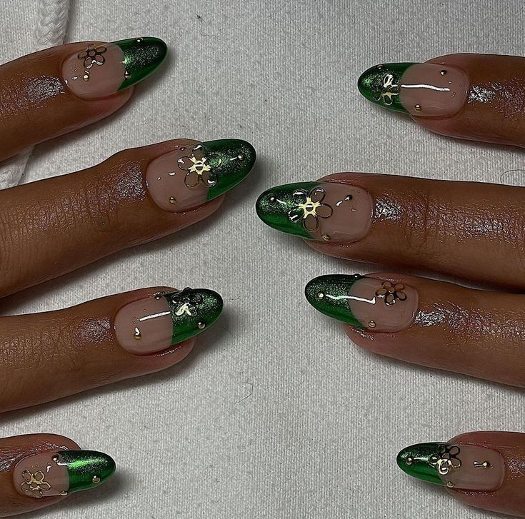 Chic Deep Green and Nude Nail Design with Floral Accents and Gold Touches.