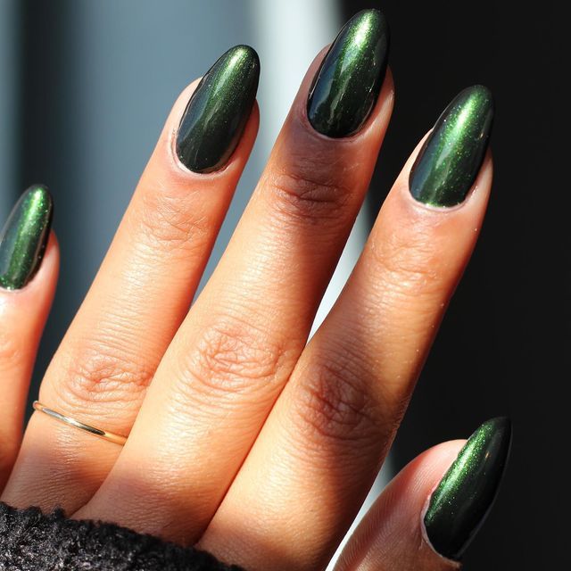 Sophisticated Green Stiletto Nails with Glossy Metallic Finish for Versatile Elegance.