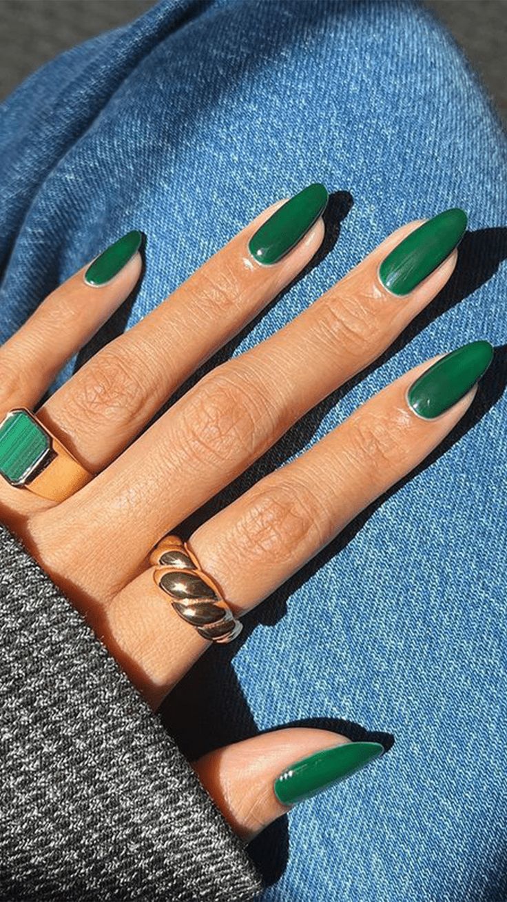 Chic Glossy Green Oval Nail Design Enhanced by Stylish Rings.