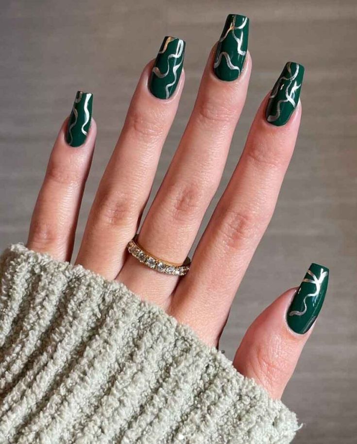 Sophisticated Glossy Green Nails with Abstract White Lines for a Chic and Modern Look.