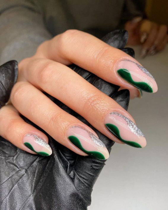 Elegant Wave-Inspired Nail Design with Muted Pink, Vibrant Green, and Silver Glitter Accents.