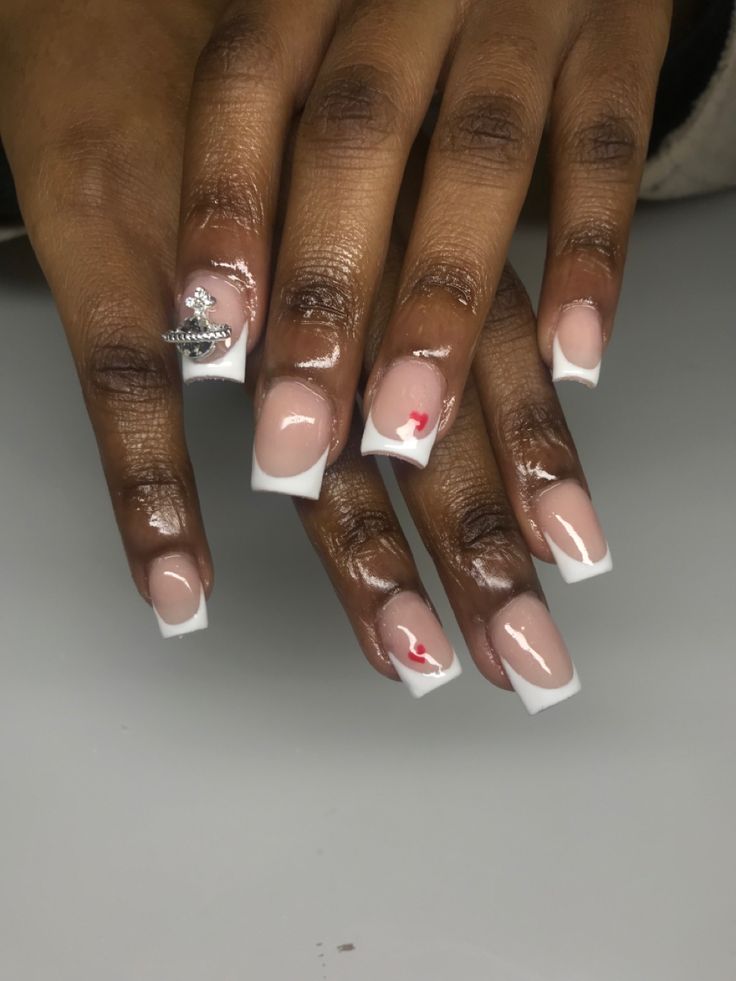 Chic French Manicure with Stylish Charm and Playful Accents.