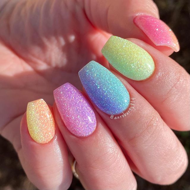 Playful Pastel Gradient Nails with Glittery Finish for a Vibrant Seasonal Look