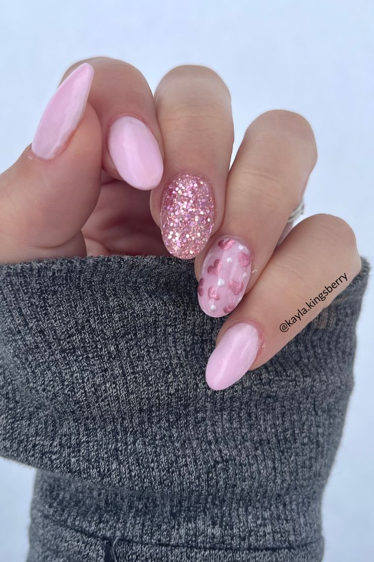 Chic Pink Nail Design with Playful Glitter and Whimsical Floral Accents.