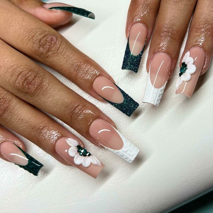 Sophisticated Nude and Green Nail Design with Floral Gems and Chic Finishes.