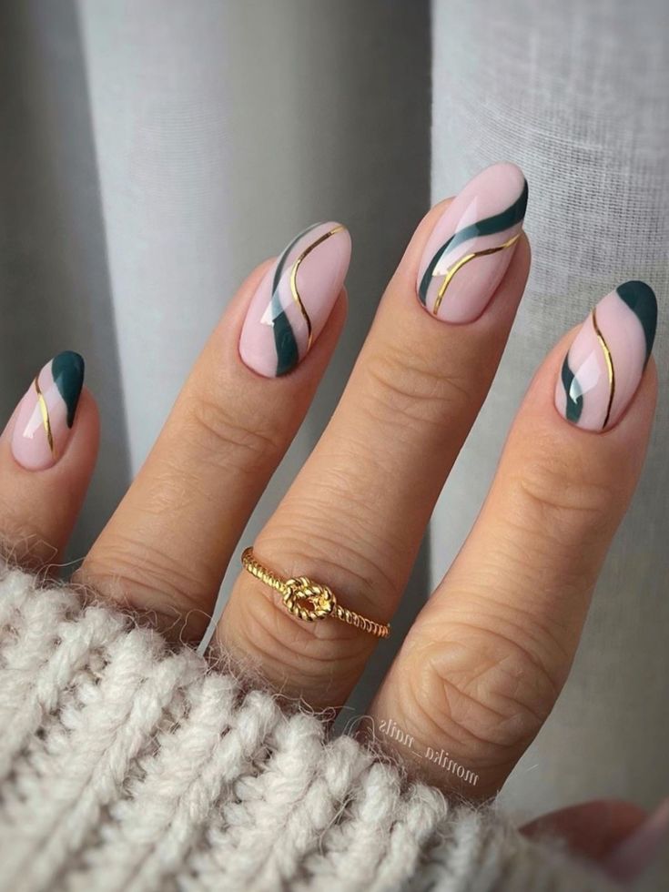 Sophisticated Elegant Nail Design: Stylish Pointed Shapes in Soft Pink and Deep Green with Golden Accents.