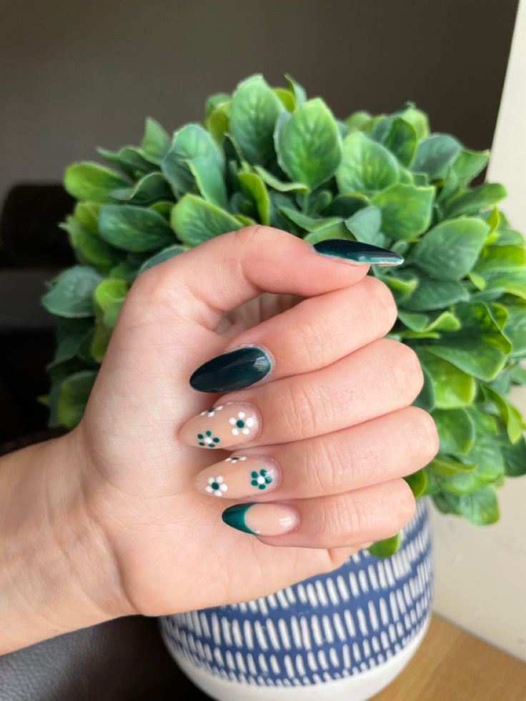 Elegant Nail Design: Dark Green and Soft Nude with Playful Floral Accents