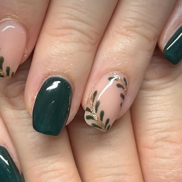 Elegant Nail Design: Deep Green and Soft Nude with Gold-Accented Leaf Motifs