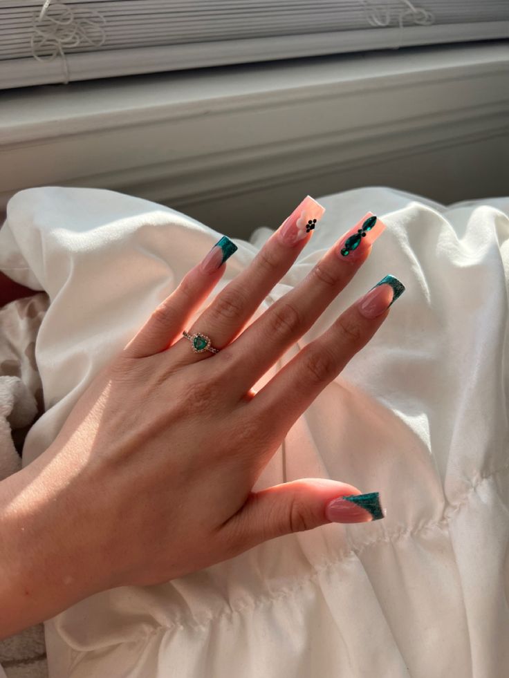 Chic Nude and Teal Nail Design with Floral Accents in Long Square Shape.