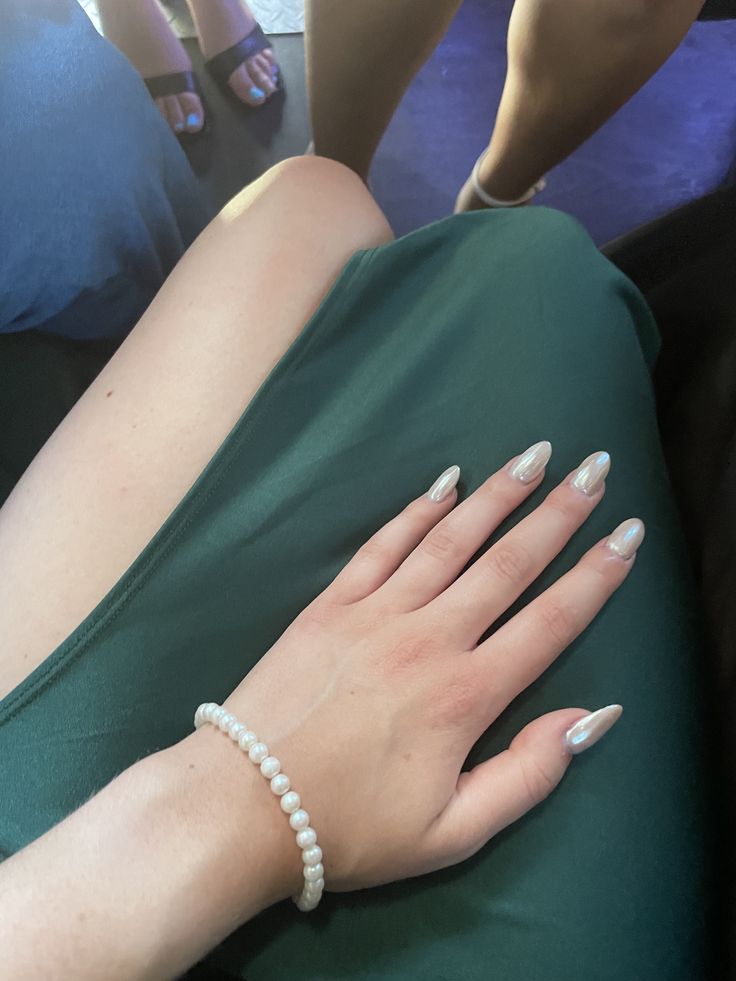 Sophisticated Metallic Silver Nail Design Complemented by a Chic Pearl Bracelet.