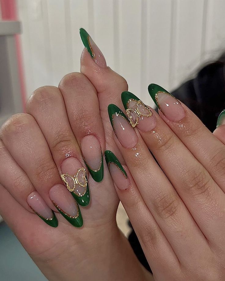 Chic Green French Tip Nail Design with Glamorous Gold Accents on Nude Base