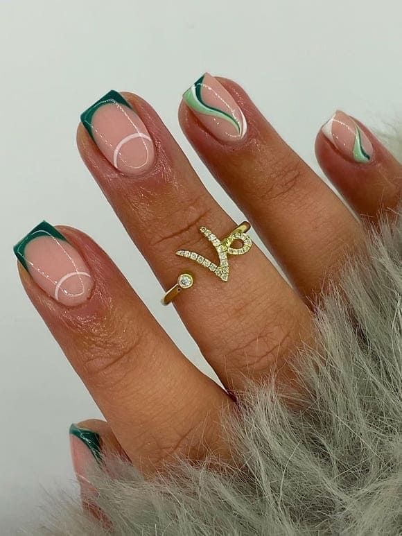 Sophisticated Modern Nail Design: Green Tips, Abstract Swirls, and Elegant Gold Accents.