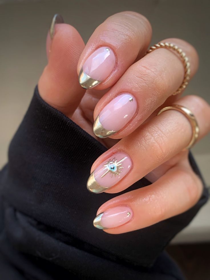 Elegant French Tip Nail Design with Modern Gold Accents and Whimsical Embellishments.