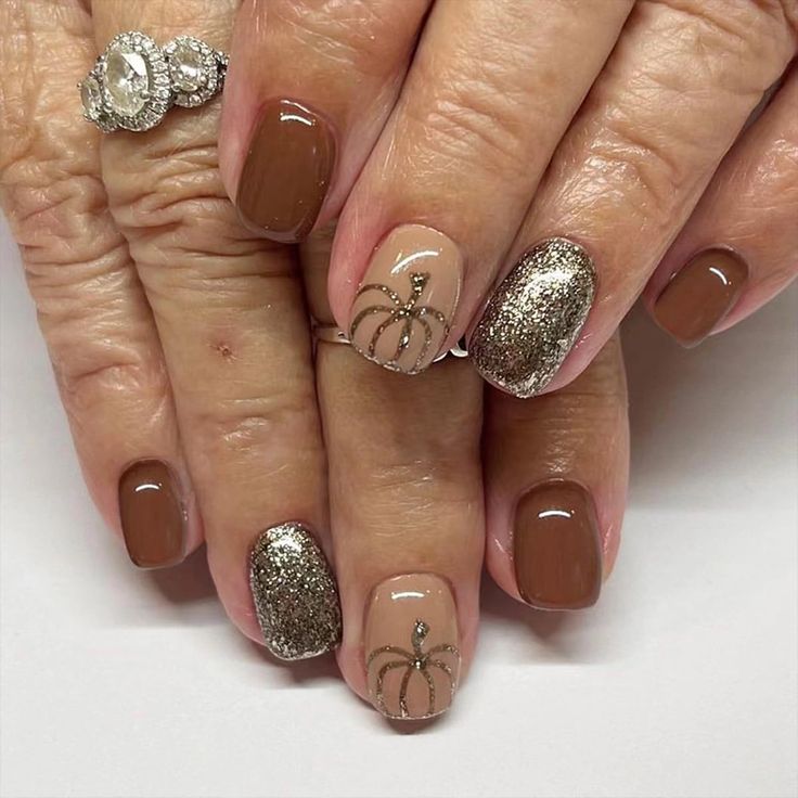 Chic Autumn Nail Design with Warm Browns and Shimmering Gold Accents.