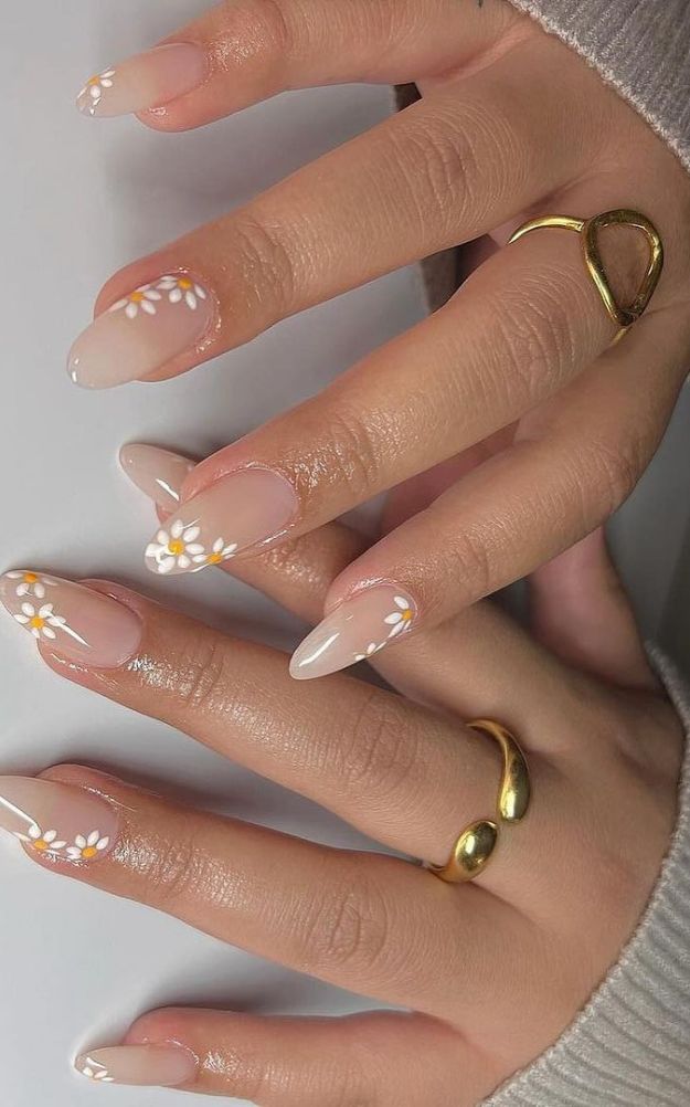 Chic Floral Nail Art: Soft Nude Base with Hand-Painted Daisies and Minimalist Gold Accents.