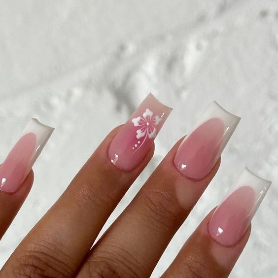 Chic Soft Pink French Tip Nails with Delicate Floral Accents