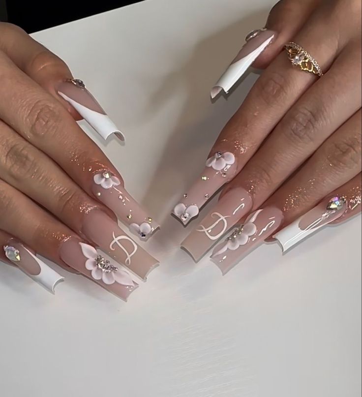 Sophisticated Floral Acrylic Nail Design with Pastel Tones and Shiny Embellishments