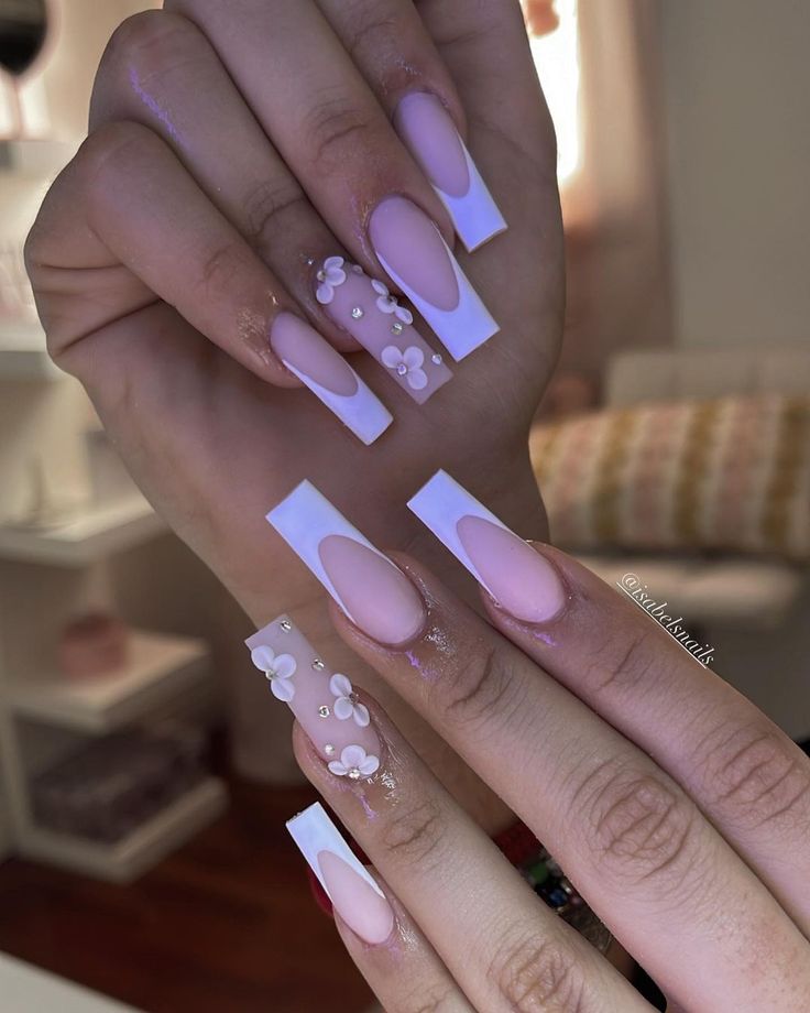 Chic Soft Pink and White Nail Art with Floral Accents and Modern Textures.