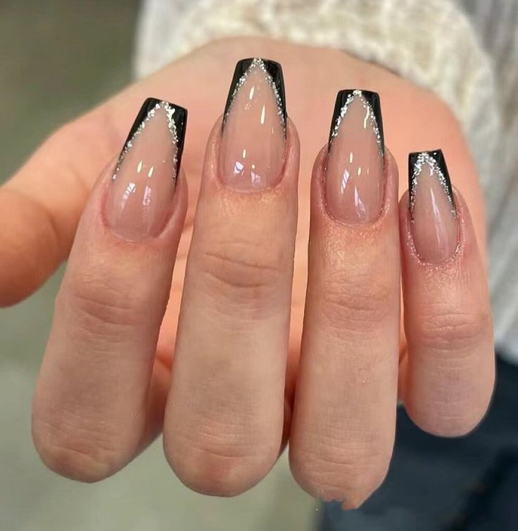 Elegant Almond-Shaped Nails: Sophisticated Nude Base with Striking Black Tips and Sparkling Edges