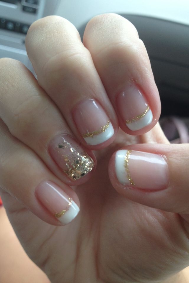 Elegant French Manicure with Gold Accents and Glittery Accent Nail for a Glamorous Touch.