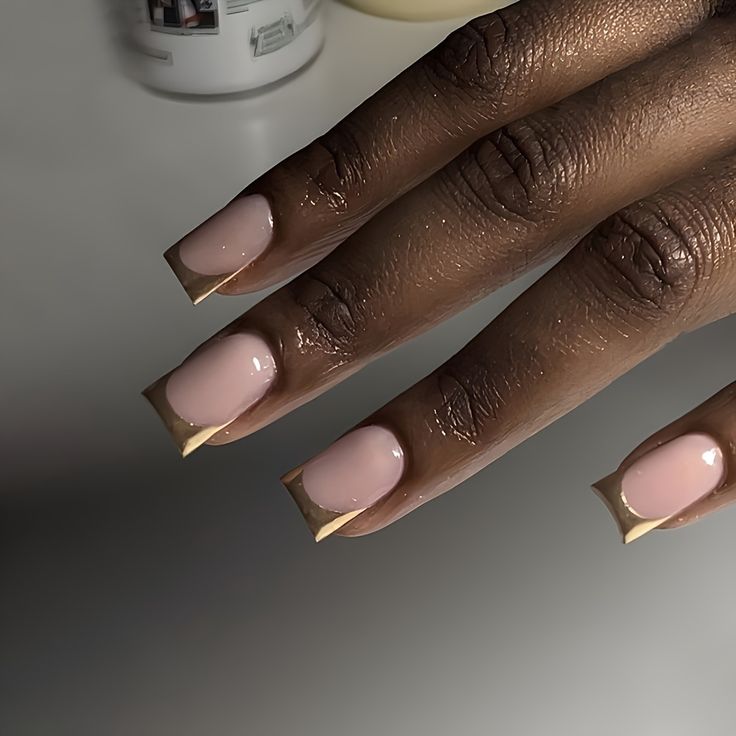 Elegant Nail Design: Nude Base with Gold Tips for a Sophisticated Look