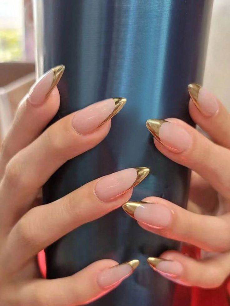 Sleek Almond-Shaped Nails with Glamorous Gold Tips: A Perfect Blend of Elegance and Modern Flair.