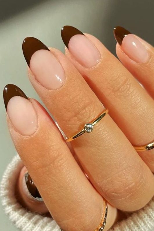 Sophisticated French Tip Nail Design with Rich Brown Tips and Delicate Gold Accents.