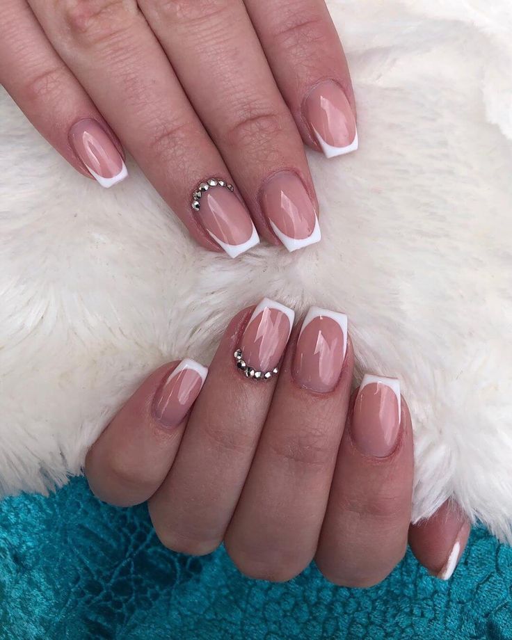 Sophisticated Nude and White Nail Design with Glamorous Rhinestones.